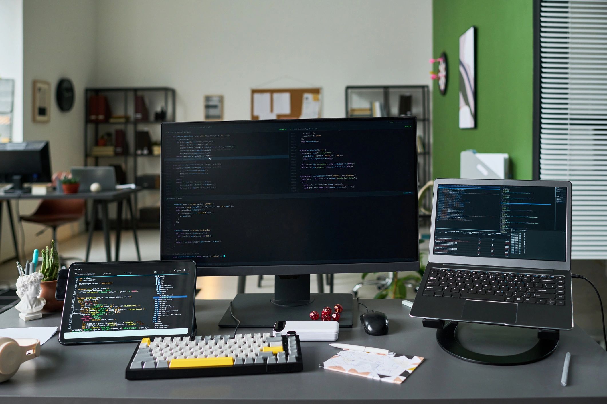 Software development workspace with code displayed on multiple screens
